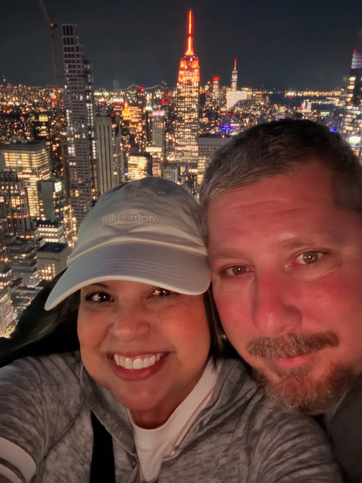 Larence and Ruthy overlooking the New York City skyline at night